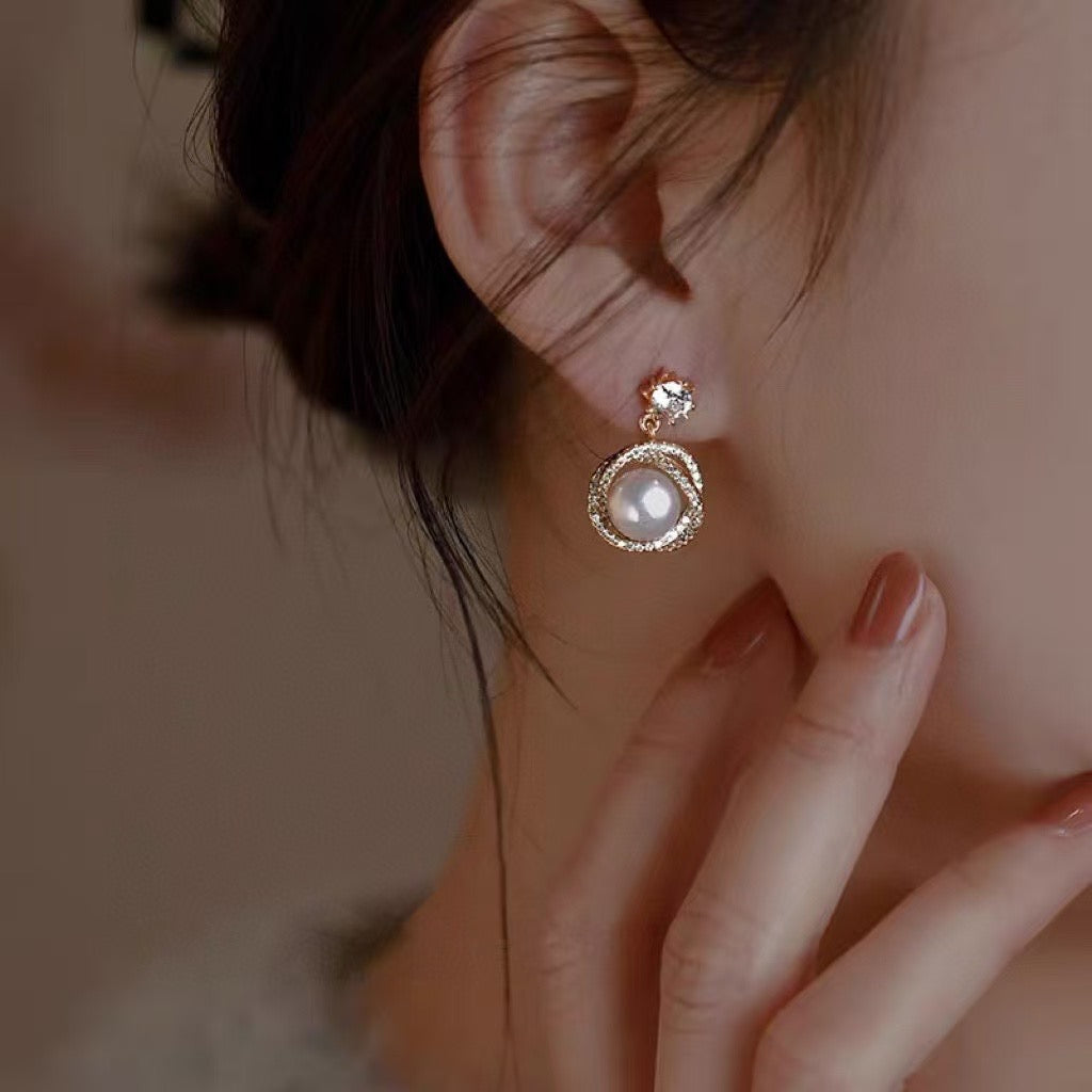 Model wearing glowing pearl studs from AnSes & Co.