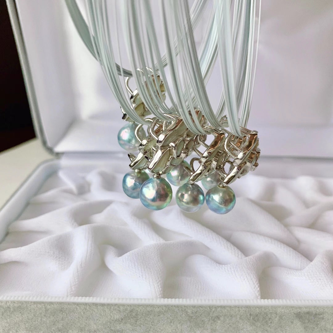 Close-up of camellia flower motif with Akoya pearl center