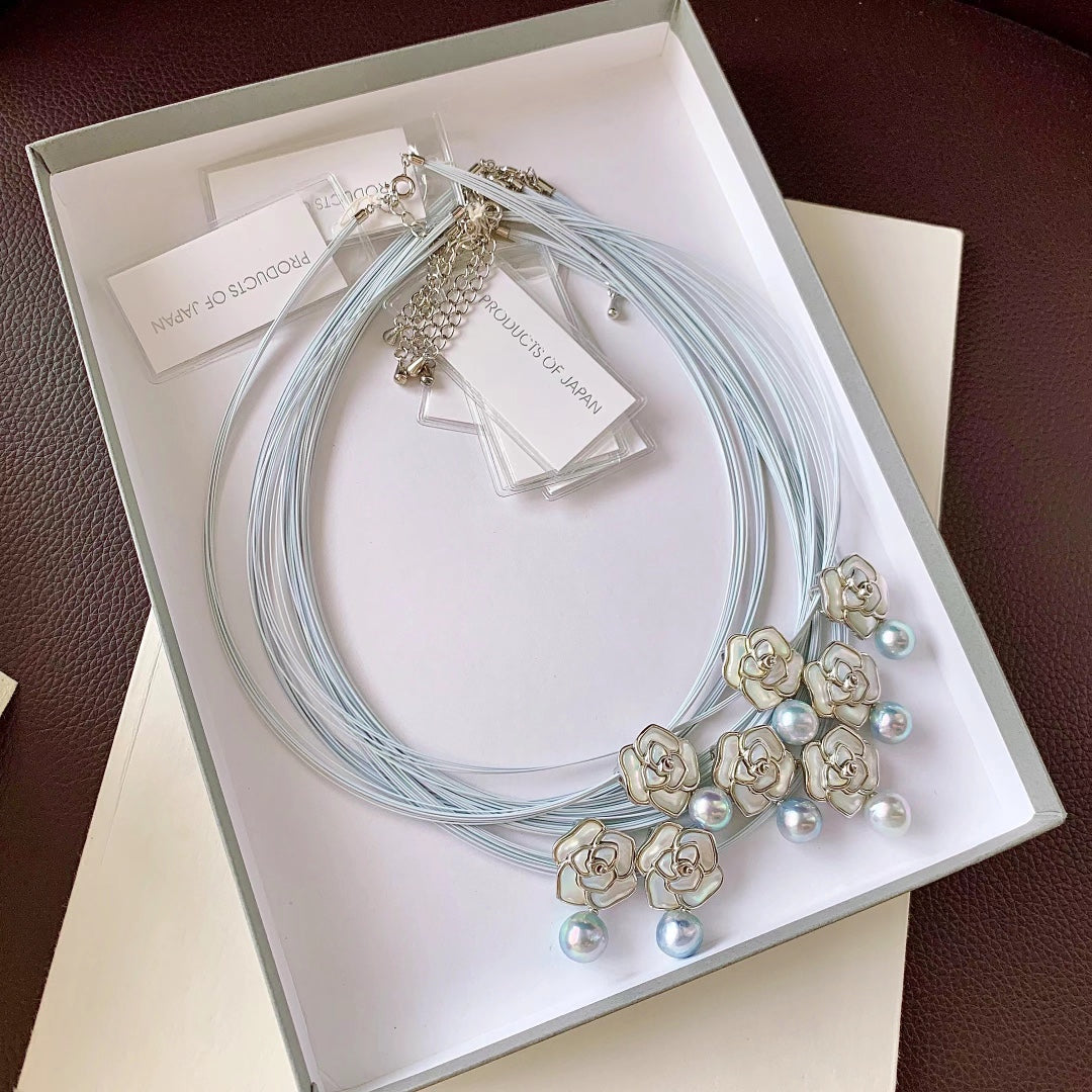 Close-up of camellia flower motif with Akoya pearl center