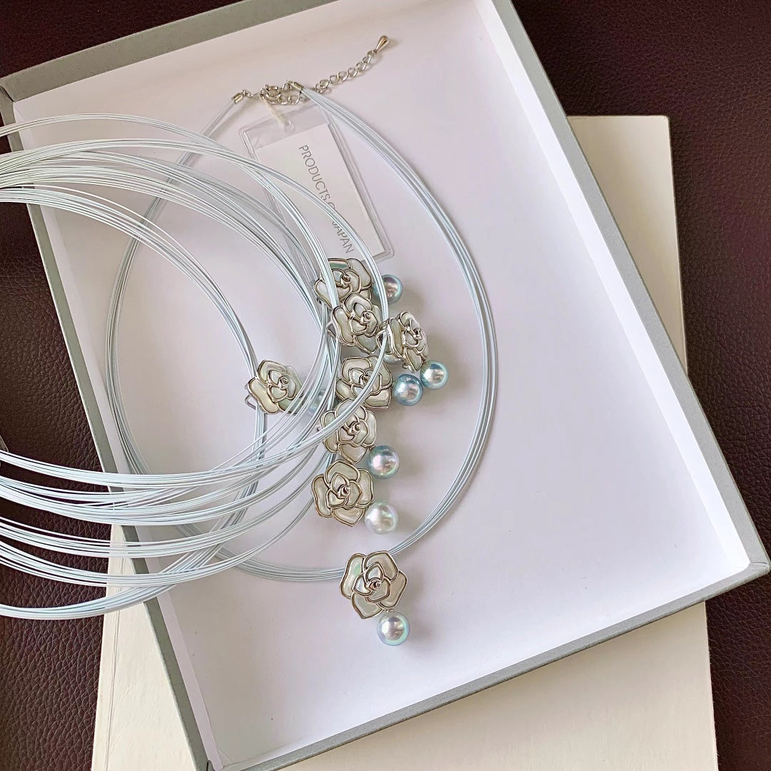 Close-up of camellia flower motif with Akoya pearl center