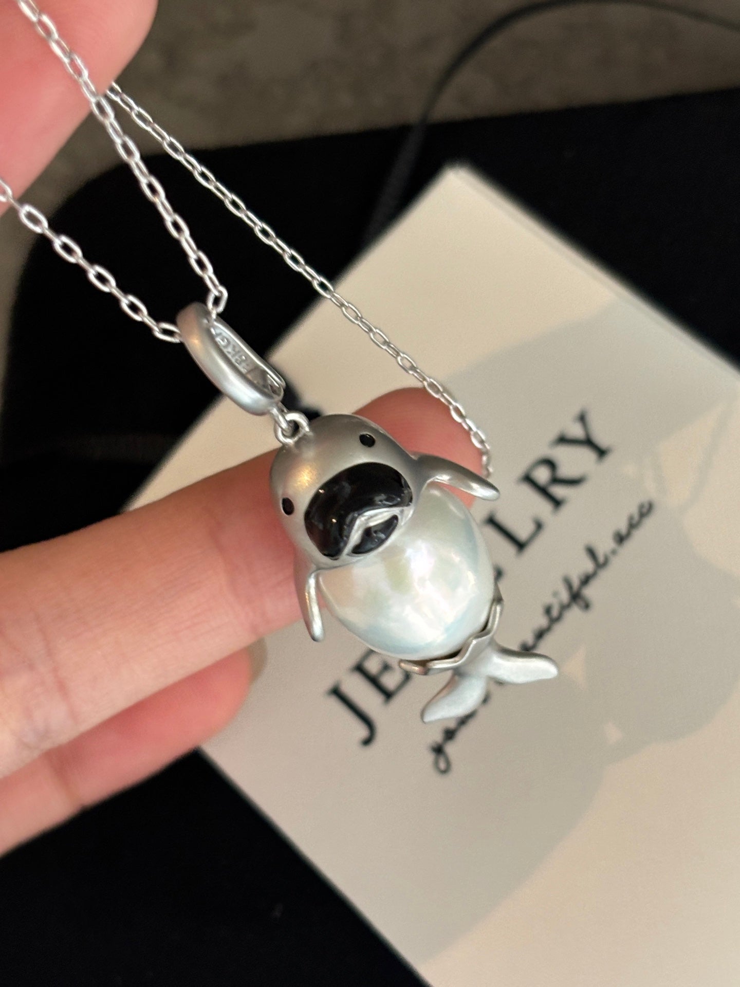 Close-up of baby seal design with 13–14mm high-luster pearl