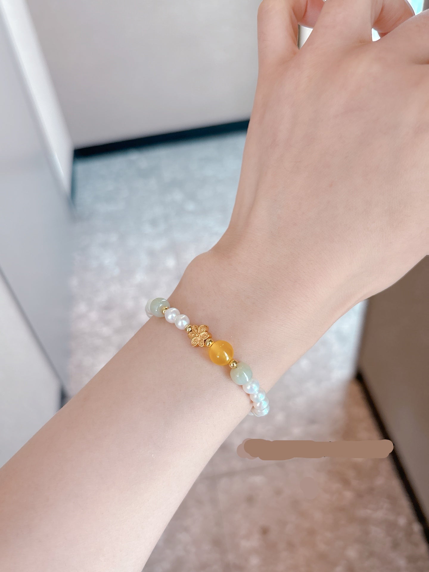 Model wearing elegant pearl and crystal bracelet