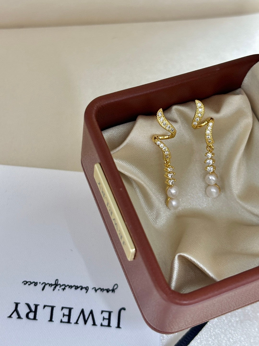 Close-up of zircon tassels and pearl drops