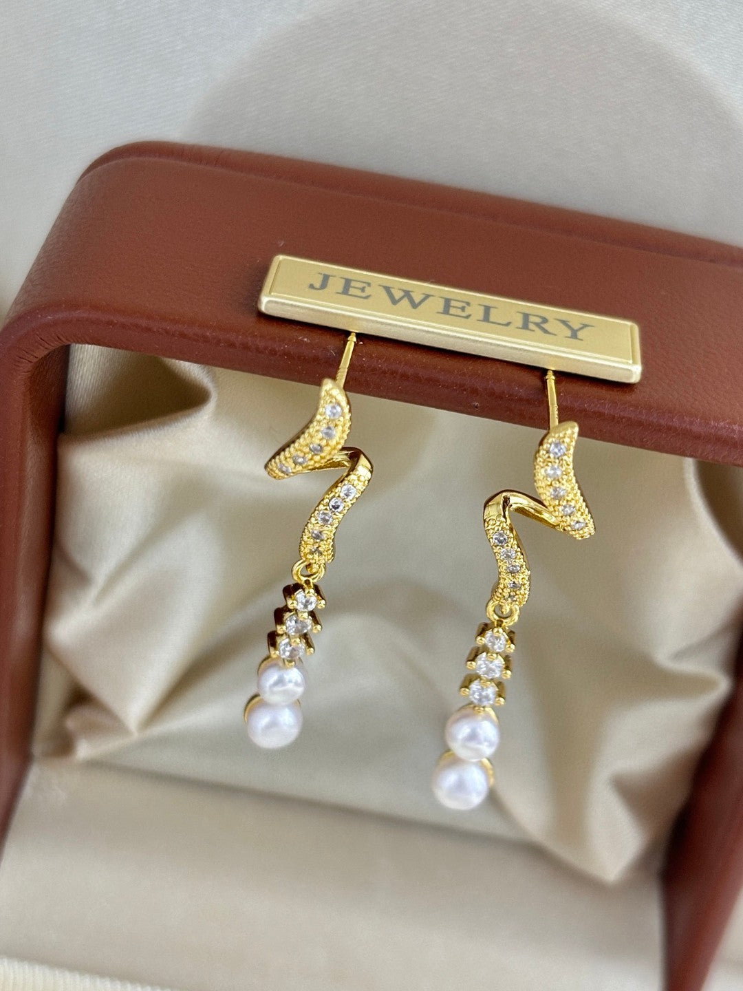 Close-up of zircon tassels and pearl drops