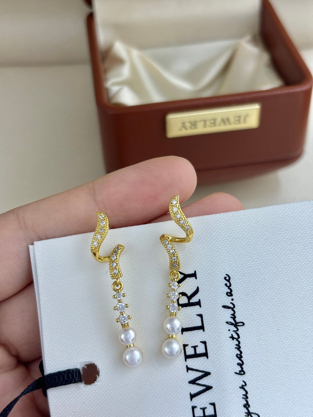 Close-up of zircon tassels and pearl drops