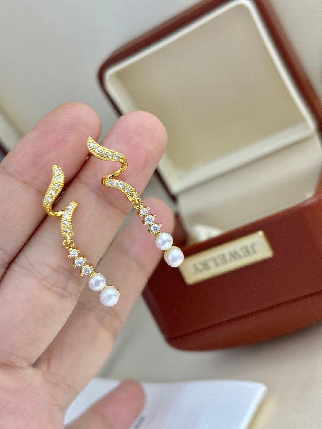 Close-up of zircon tassels and pearl drops