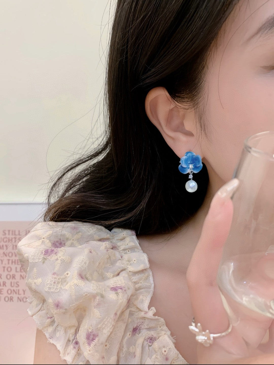 Model wearing blue porcelain pearl earrings