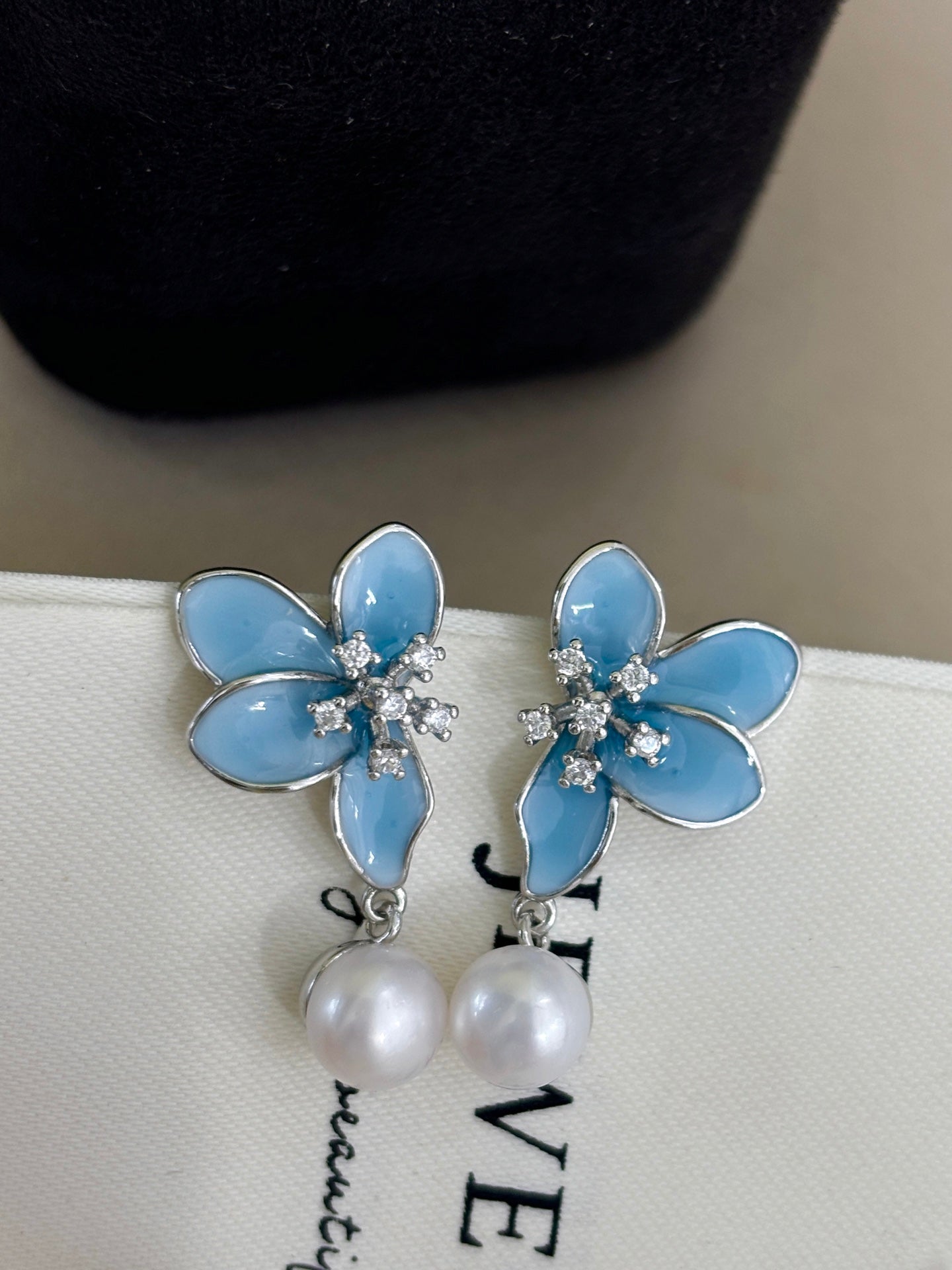 Close-up of 3D blue petals and pearl detail