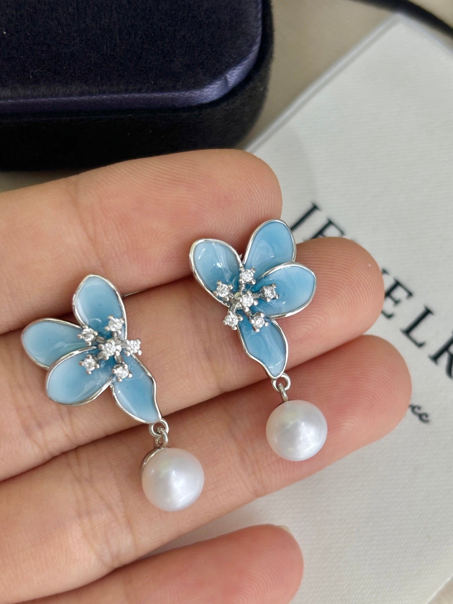 Close-up of 3D blue petals and pearl detail