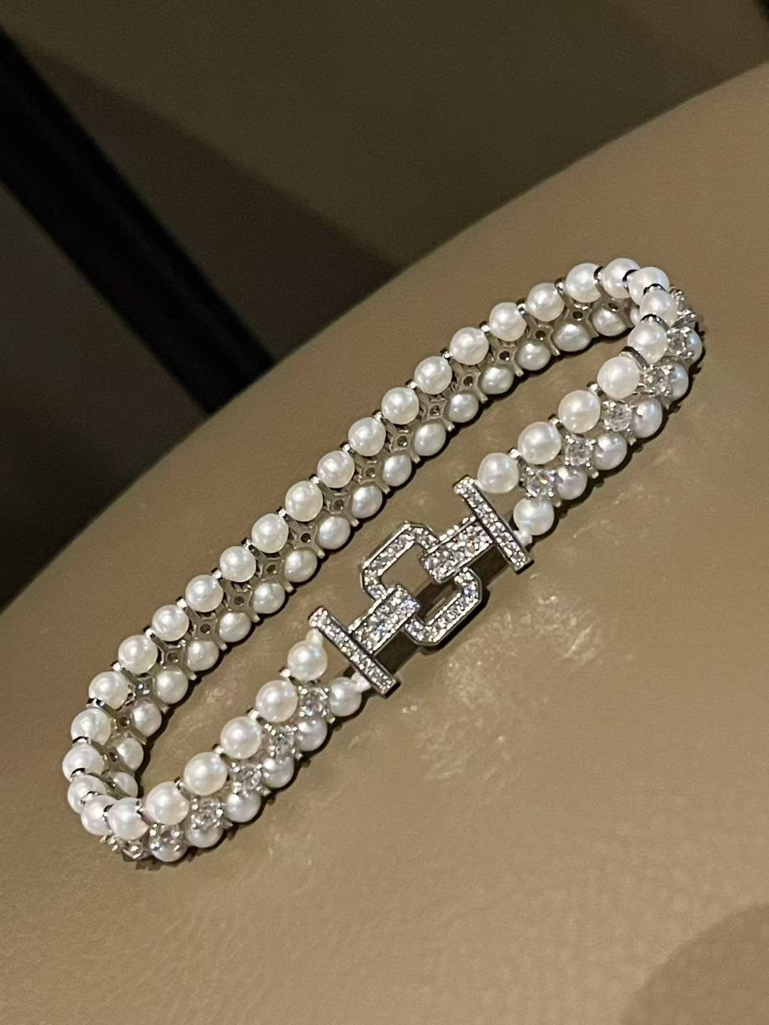 Haute couture pearl bracelet with zircon accents and heavy clasp