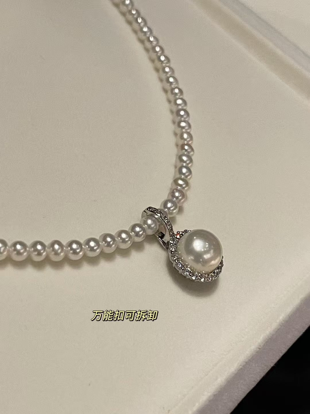 Close-up of high-luster pearls and sunflower charm with zircon accents
