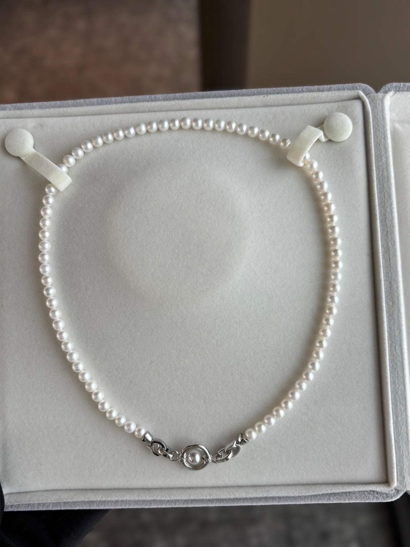 Universal clasp pearl necklace with 5–6mm freshwater pearls on white background