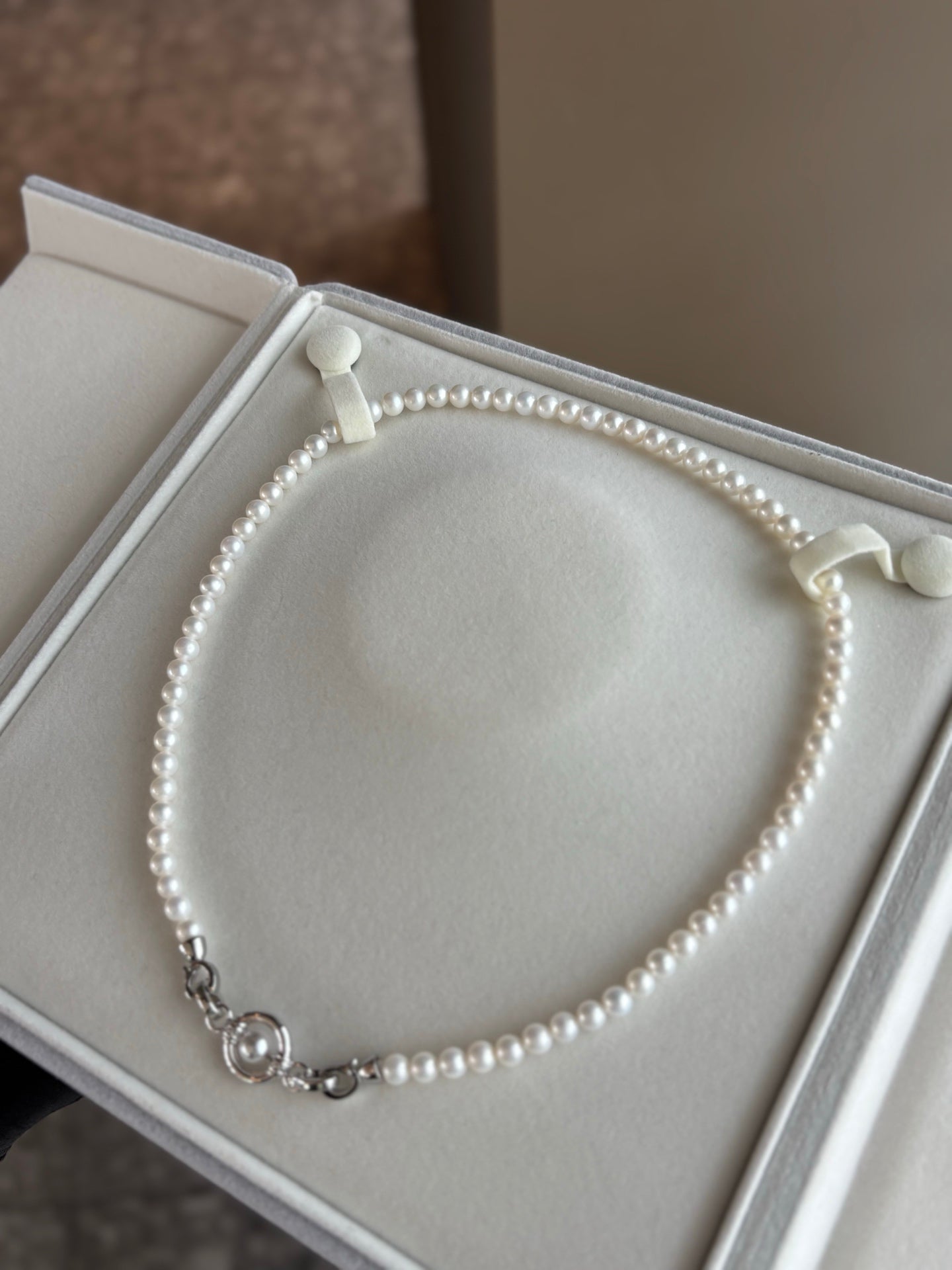 Universal clasp pearl necklace with 5–6mm freshwater pearls on white background