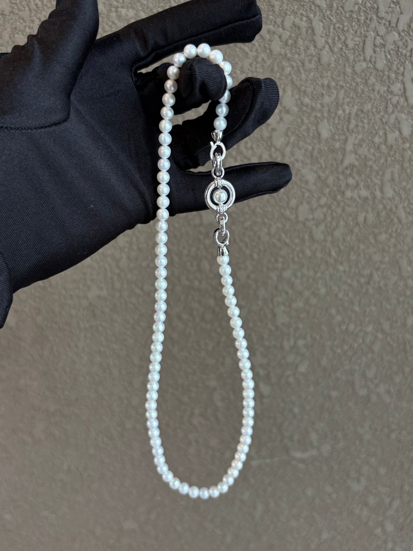Close-up of sliding clasp and natural round pearls