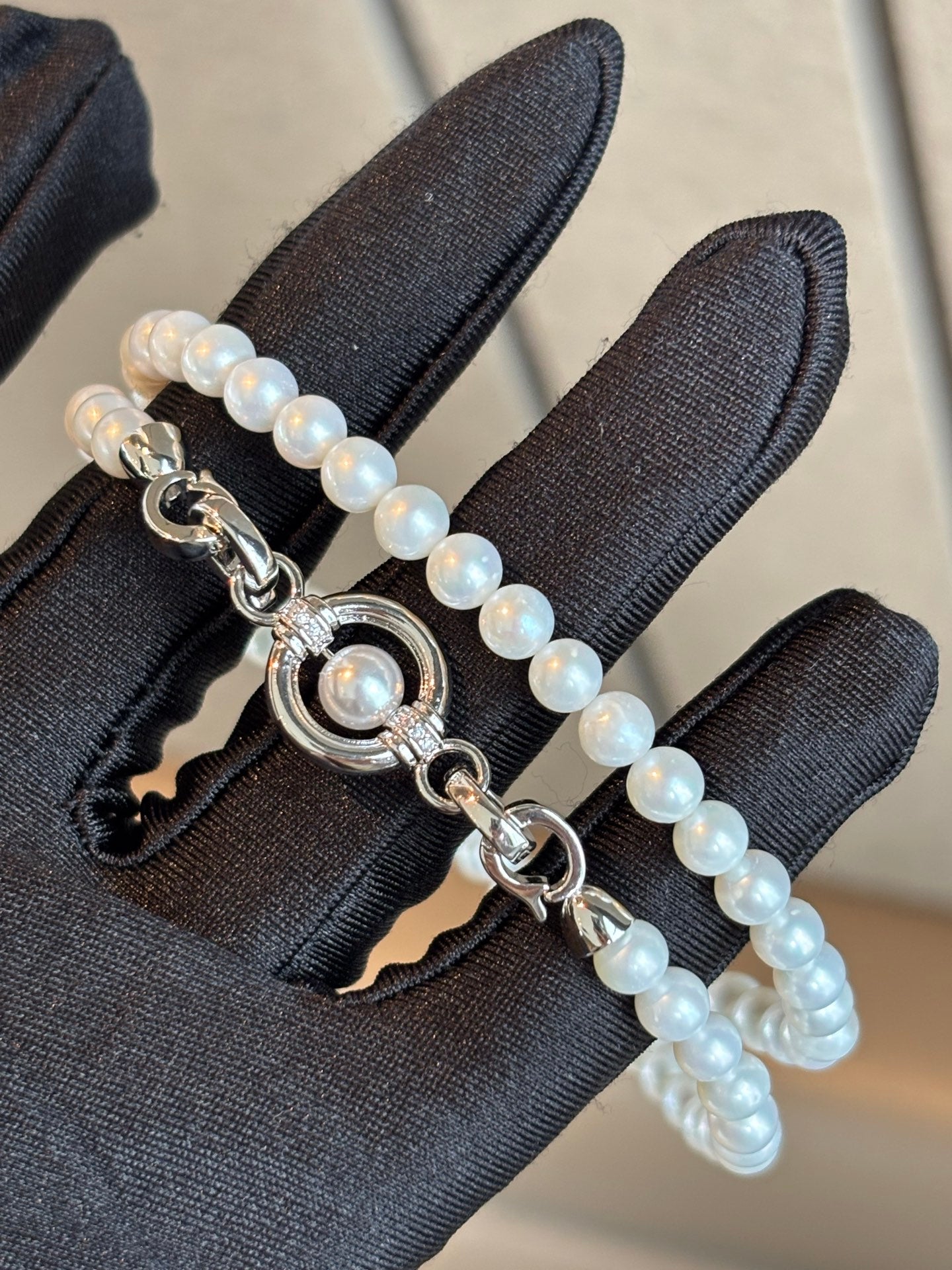Close-up of sliding clasp and natural round pearls