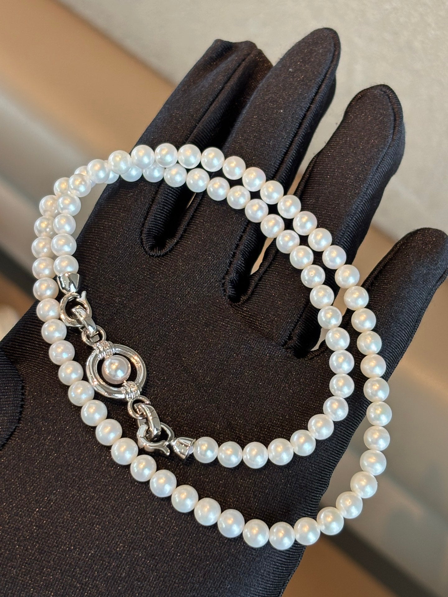 Close-up of sliding clasp and natural round pearls