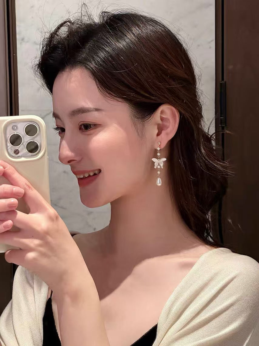 White mother-of-pearl butterfly earrings with tassels and freshwater pearls in Chinese-style design