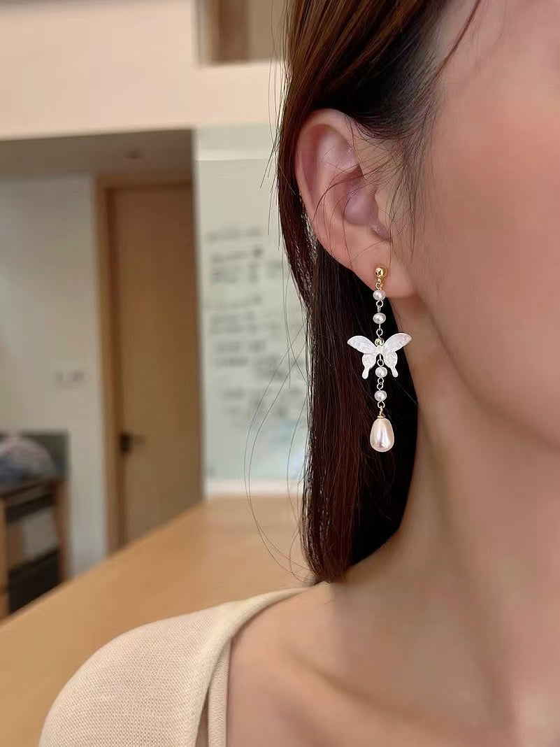 White mother-of-pearl butterfly earrings with tassels and freshwater pearls in Chinese-style design