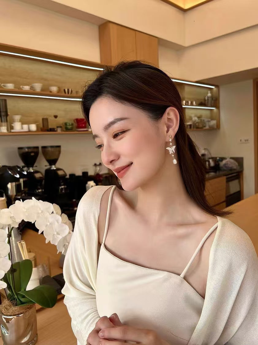 White mother-of-pearl butterfly earrings with tassels and freshwater pearls in Chinese-style design
