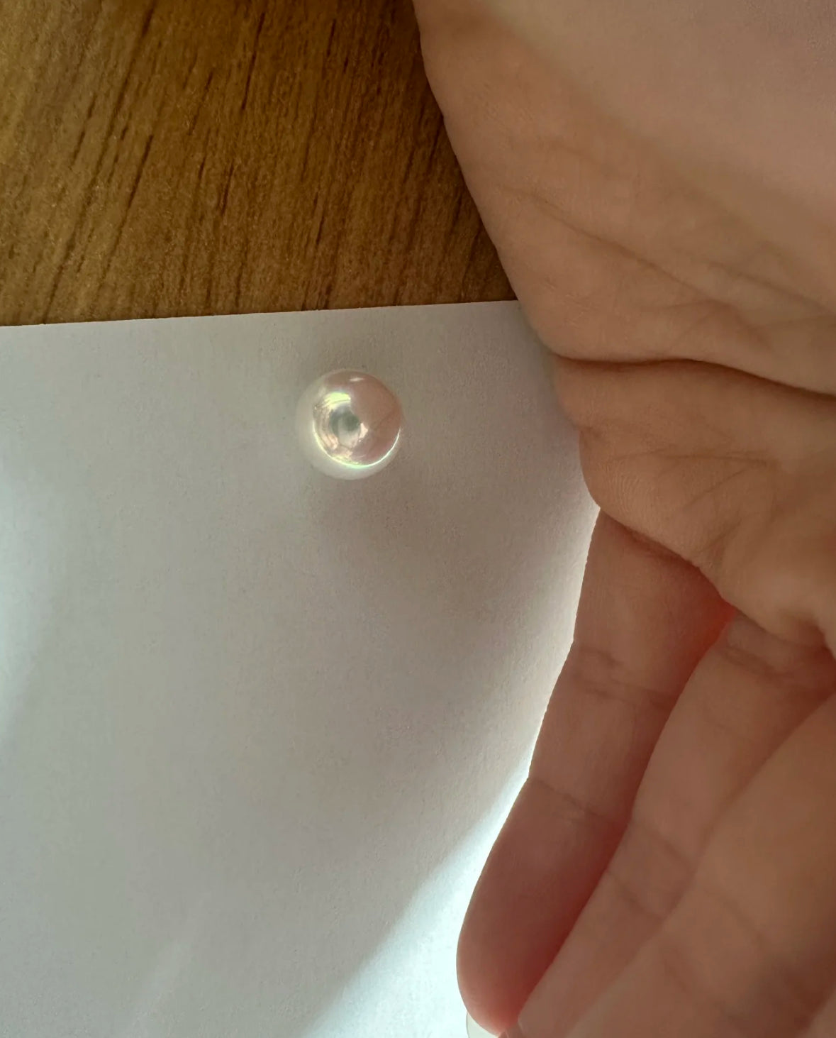 Close-up of a cool white, round Edison freshwater pearl with high luster