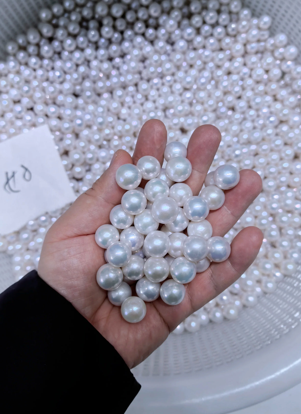 Close-up of a cool white, round Edison freshwater pearl with high luster
