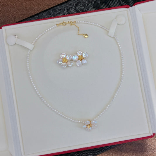 A handcrafted pearl necklace and earrings set featuring delicate petal designs and 3.5–4mm freshwater pearls, perfect for spring.
