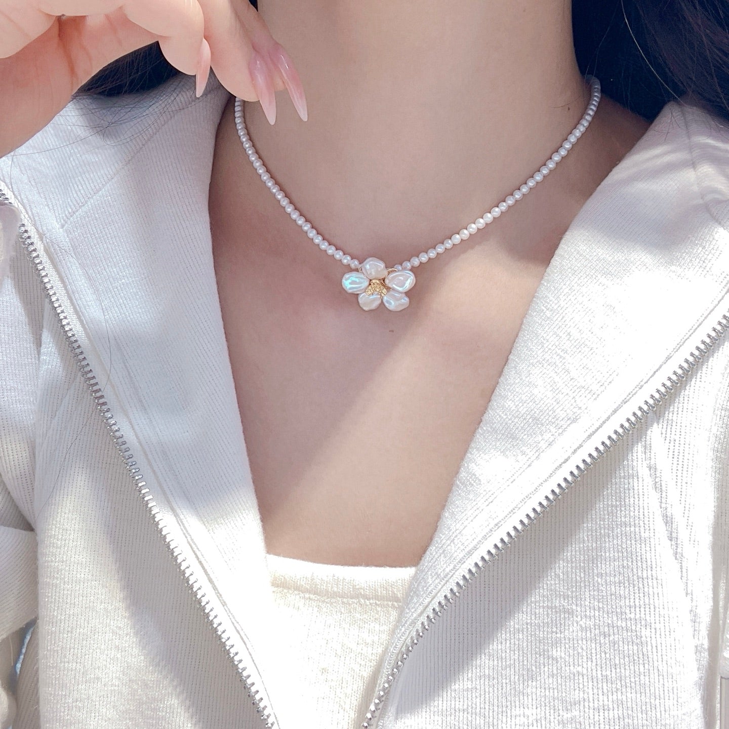 A handcrafted pearl necklace and earrings set featuring delicate petal designs and 3.5–4mm freshwater pearls, perfect for spring.