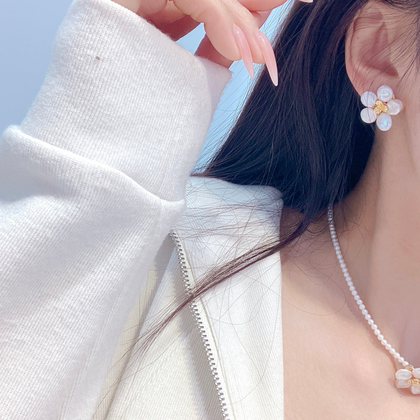 A handcrafted pearl necklace and earrings set featuring delicate petal designs and 3.5–4mm freshwater pearls, perfect for spring.