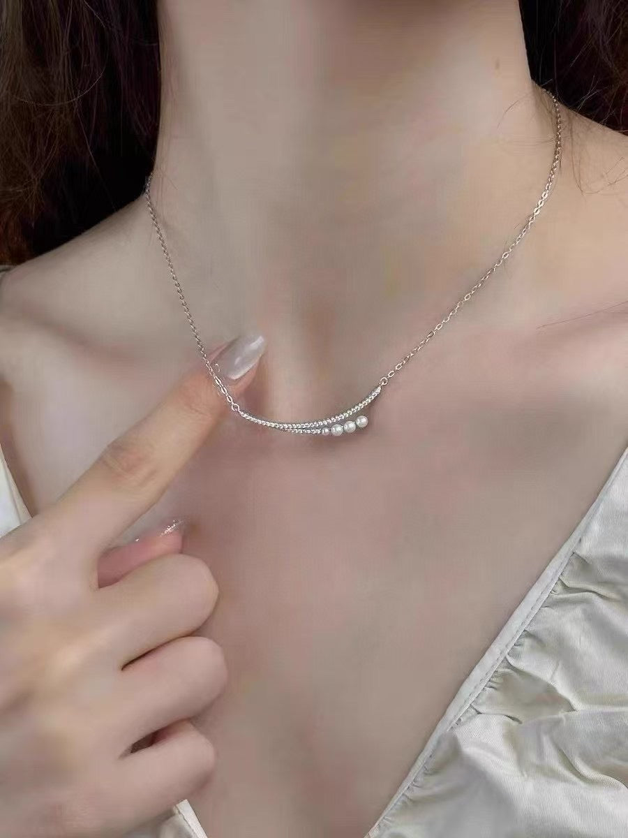 Crescent moon pendant necklace with gradient freshwater pearls in a soft, elegant arrangement.