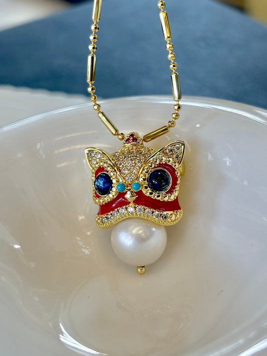 Chinese guardian lion brooch and pendant with Edison pearl, symbolizing luck, prosperity, and elegance.
