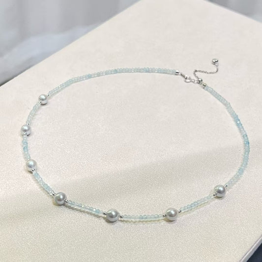 Sterling silver necklace featuring aquamarine stones and 6–7mm grey Akoya baroque pearls, elegant ocean-inspired jewelry.