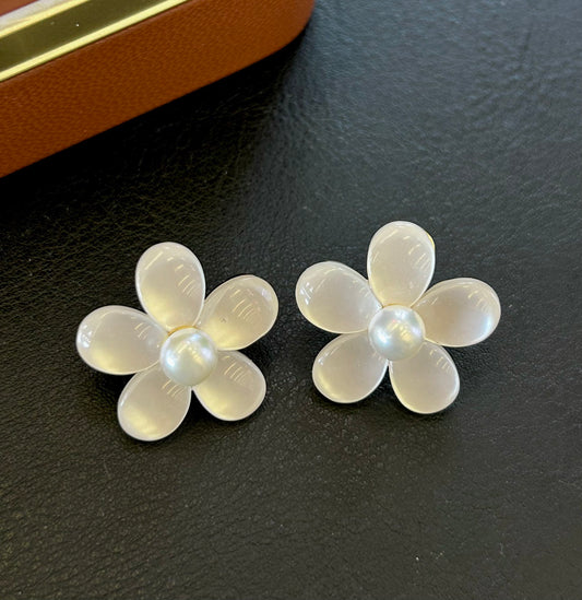 Elegant pearl and cat’s eye floral stud earrings with sterling silver posts.