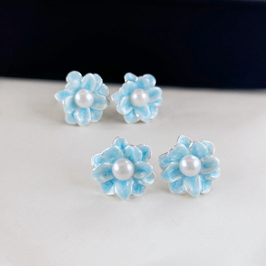 Ice blue floral pearl stud earrings with freshwater pearls and silver posts.