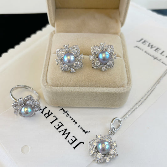 Elegant pearl jewelry set featuring four-leaf clover earrings, ring, and pendant with Akoya pearls and ice-crystal design.