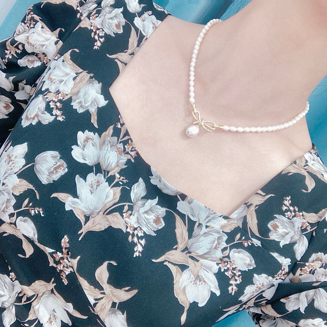Bow-tie design pearl necklace with freshwater pearls and gold-plated chain