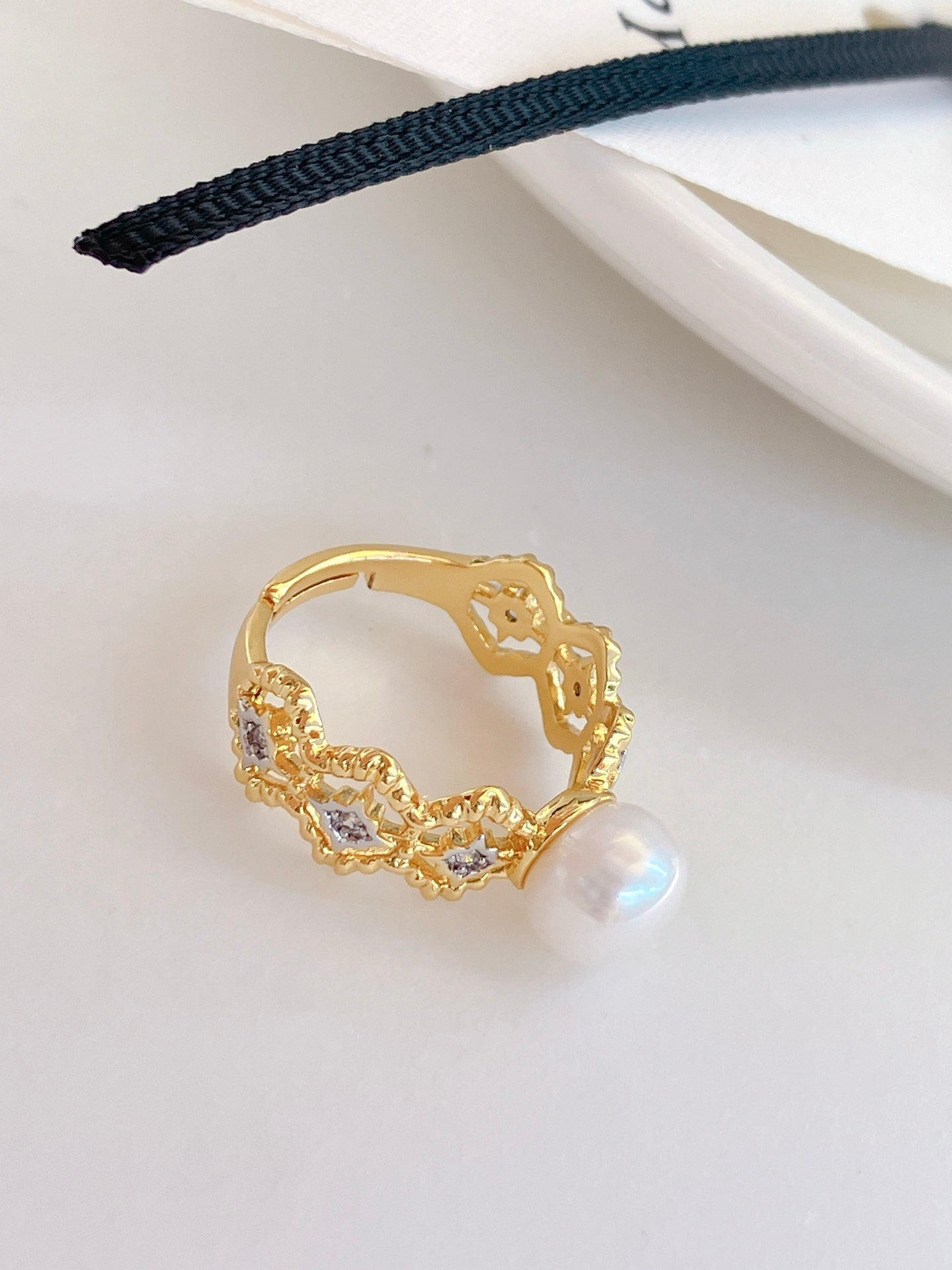 Adjustable gold open ring with geometric cut-out design and freshwater pearl