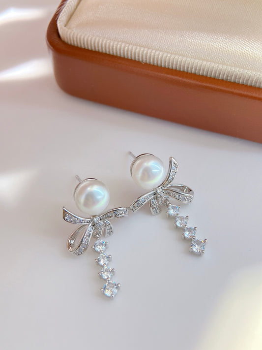 Model wearing silk ribbon bow pearl stud earrings
Close-up of freshwater pearl bow stud earrings
