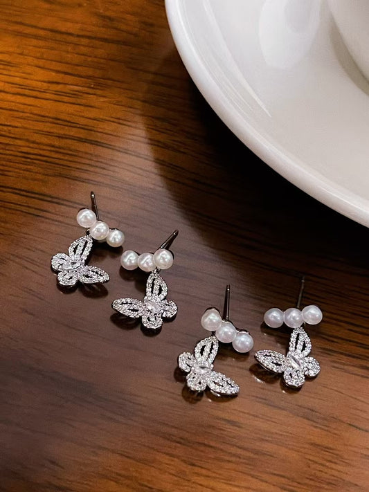 Elegant butterfly-shaped pearl earrings with 4–5mm freshwater pearls and silver ear posts