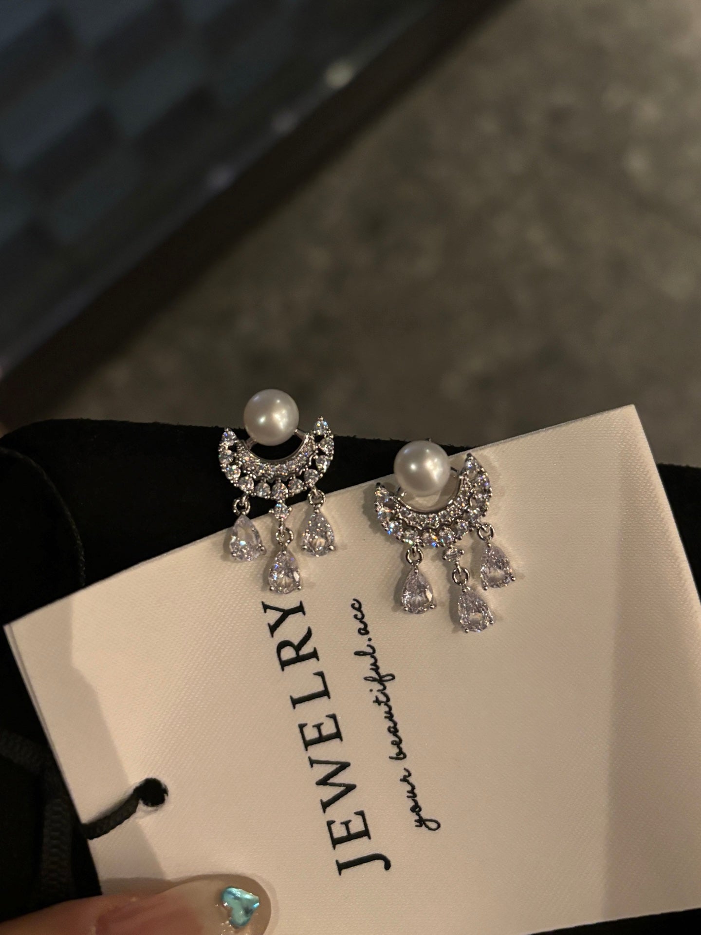 Shimmering tassel-style earrings with waterdrop pearls and sparkling zirconia on silver posts