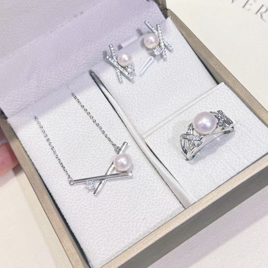 Three-piece pearl jewelry set with earrings, pendant, and ring in silver-tone 14k gold finish