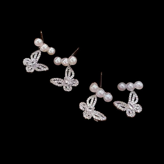 Butterfly pearl stud earrings with 4-5mm freshwater pearls on white background