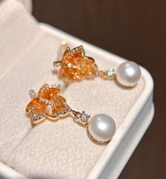 Gradient red maple leaf crystal earrings with freshwater pearl drops on white background