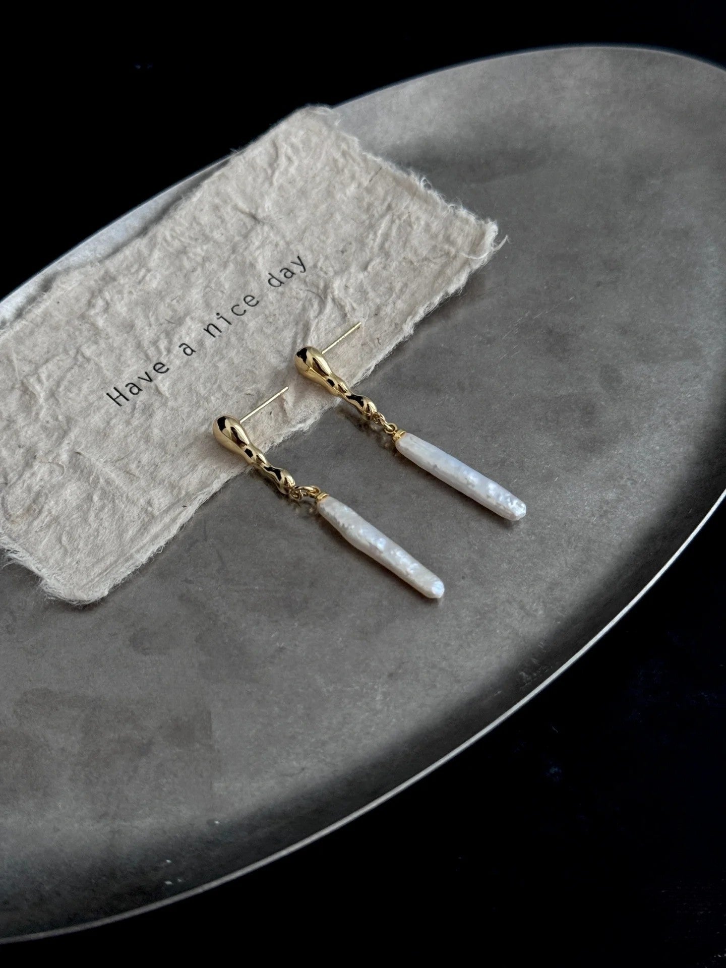 Close-up of irregular freshwater baroque pearls in gold or silver drop setting
