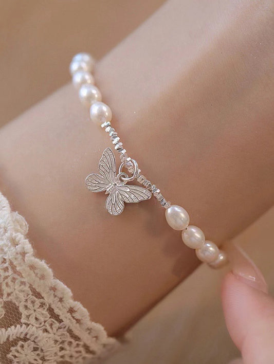 Silver butterfly pearl bracelet with 16cm chain and 3cm extender on white background