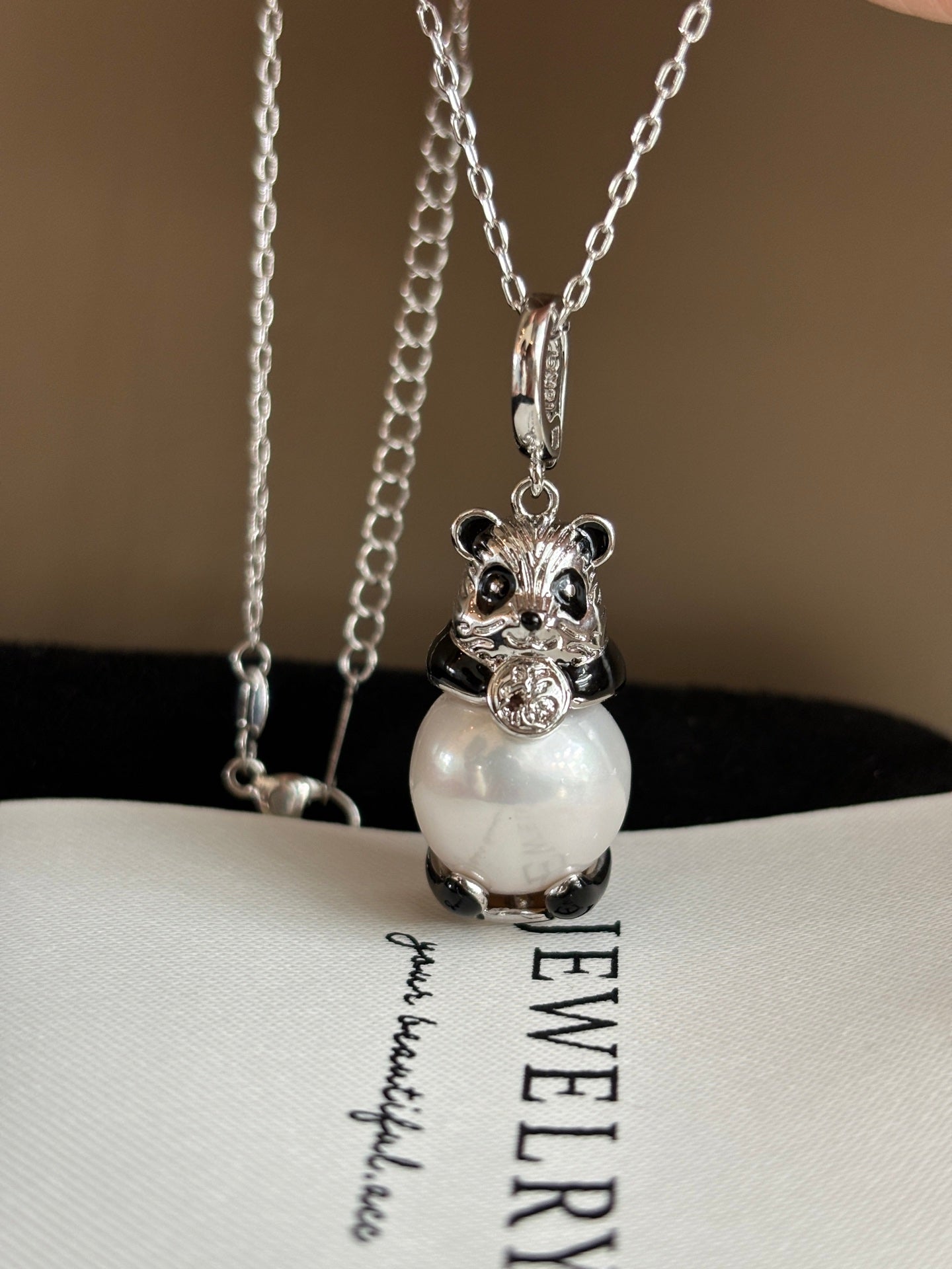 Close-up of high-luster Edison pearl and panda charm