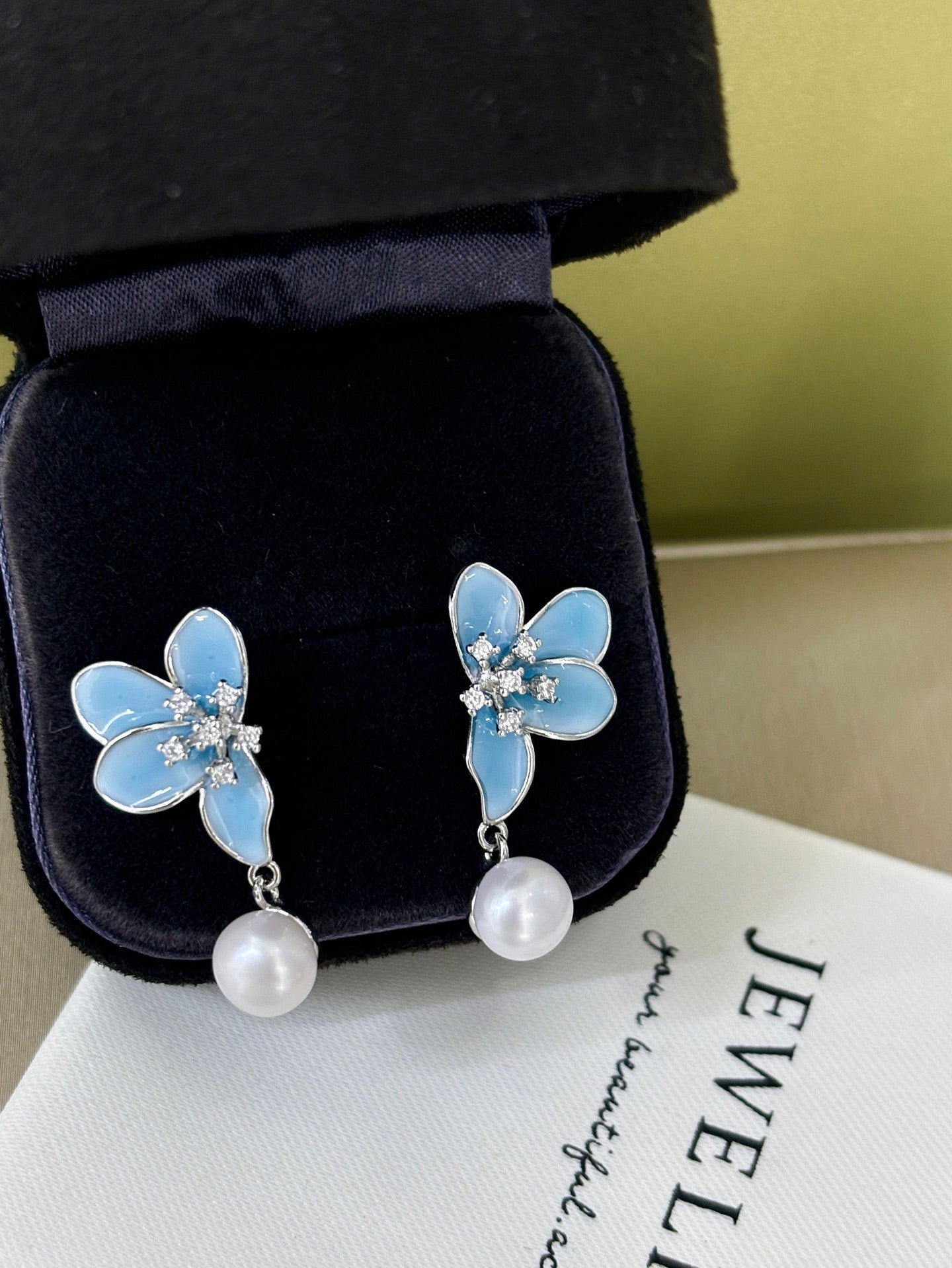 Close-up of 3D blue petals and pearl detail