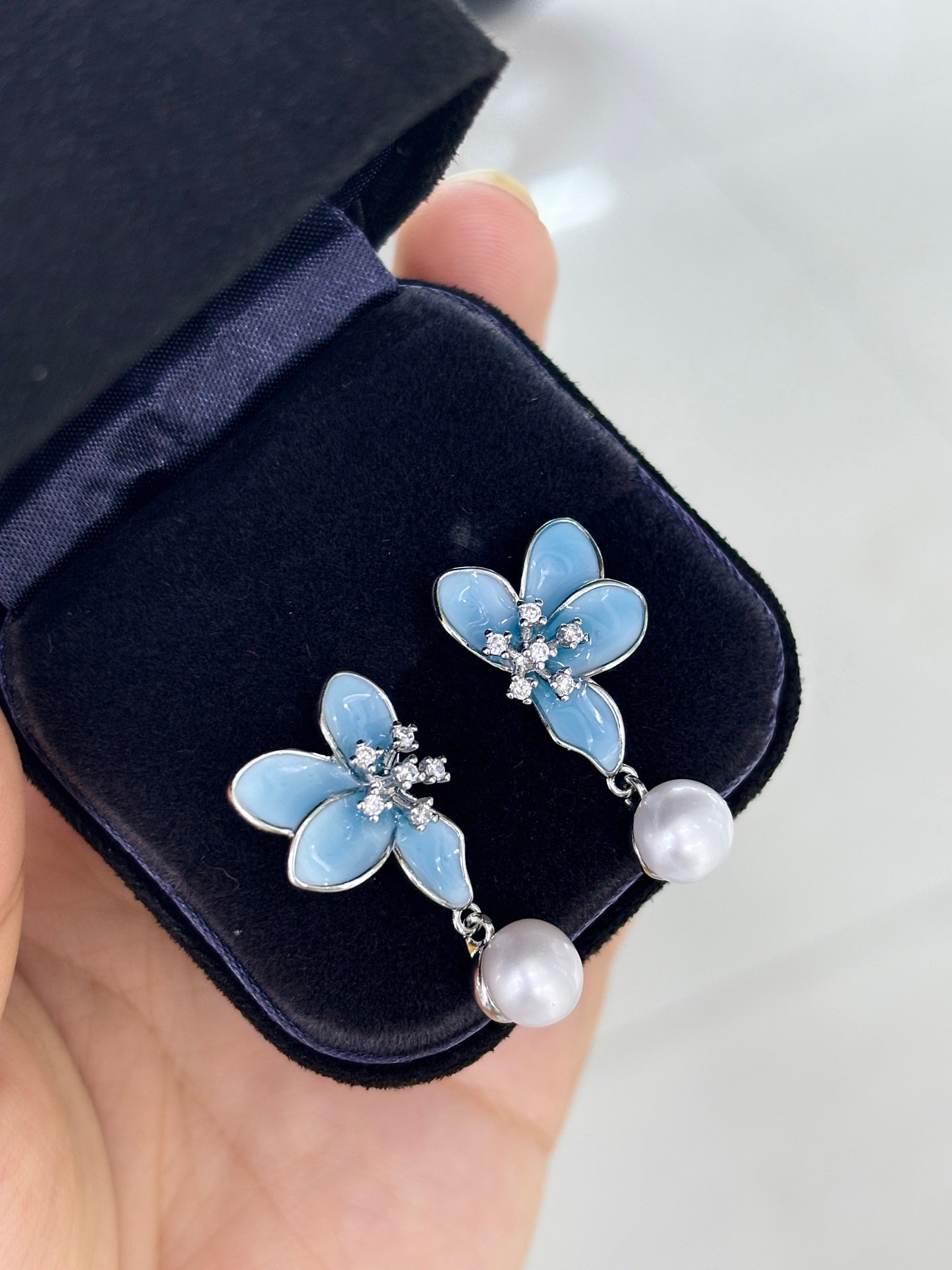 Close-up of 3D blue petals and pearl detail