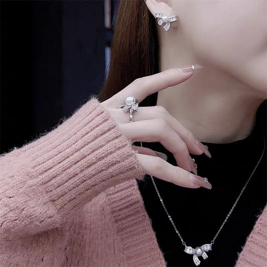 Model wearing complete bow pearl jewelry set