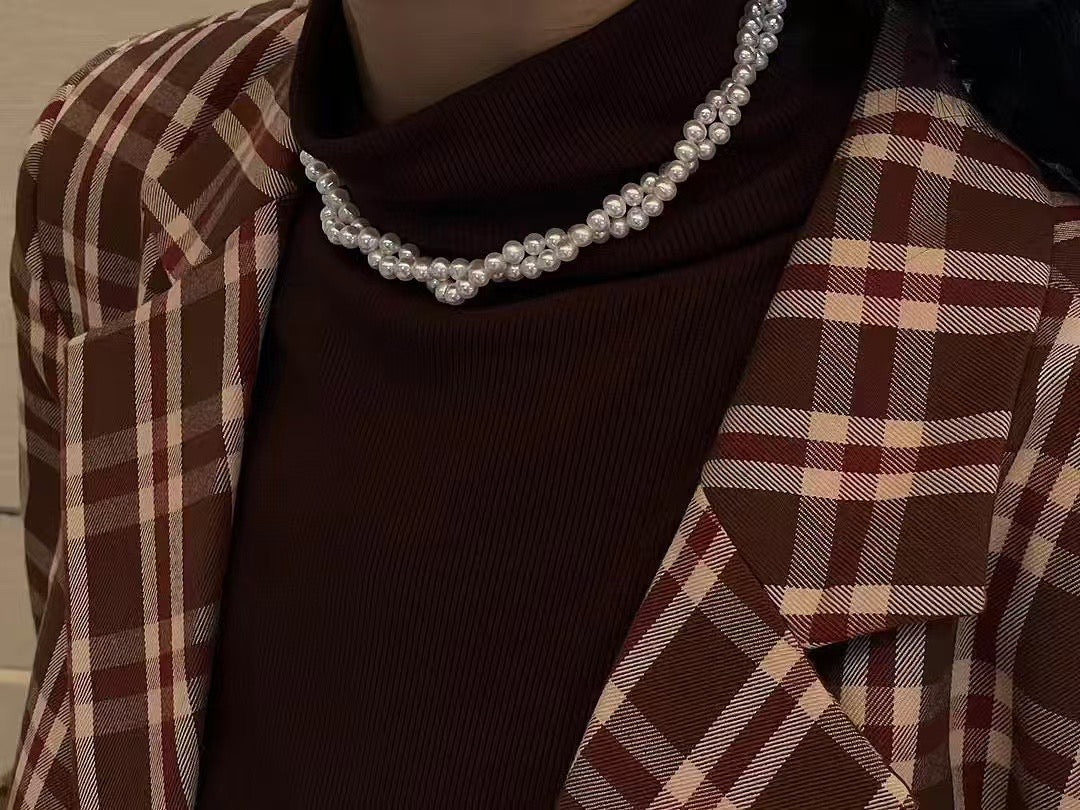 Model wearing pearl choker in layered and wrap-around style