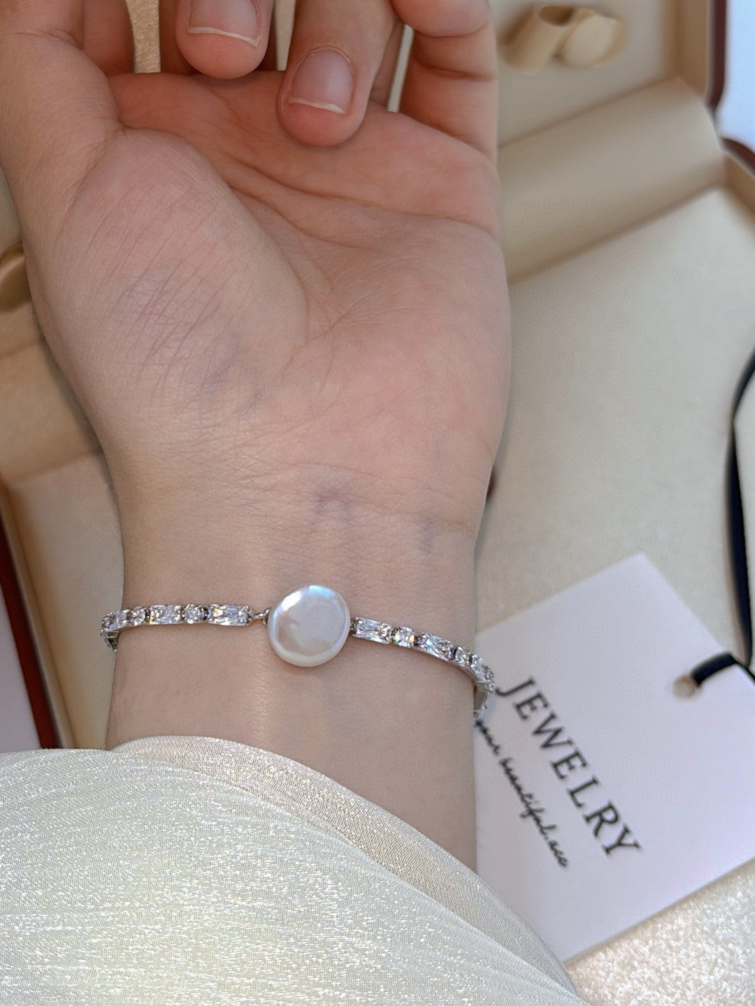 Model wearing modern oriental pearl bracelet